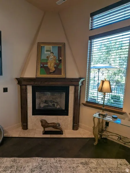 Corner fireplace featuring a wood mantel and tile surround