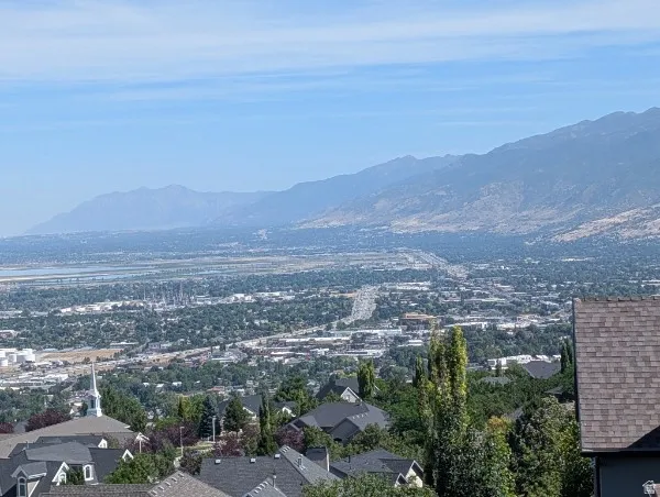 Expansive mountain and city scenery with distant water elements