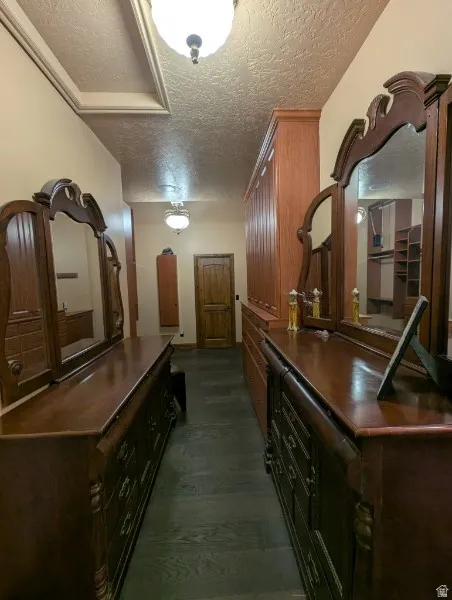 Primary bedroon colset with built-in wood shelving and drawers provide organization