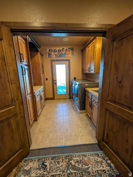 Laundry area with tile flooring
