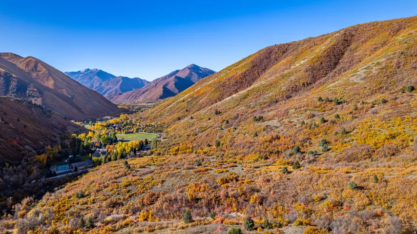 Valley setting with surrounding mountains and expansive natural landscaping