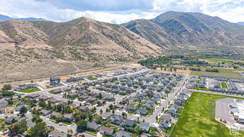 Expansive residential community with established homes, green spaces, and mountain backdrops