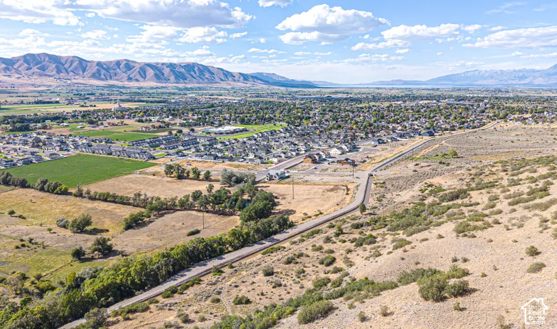 Expansive natural landscape with distant mountain ranges and a body of water