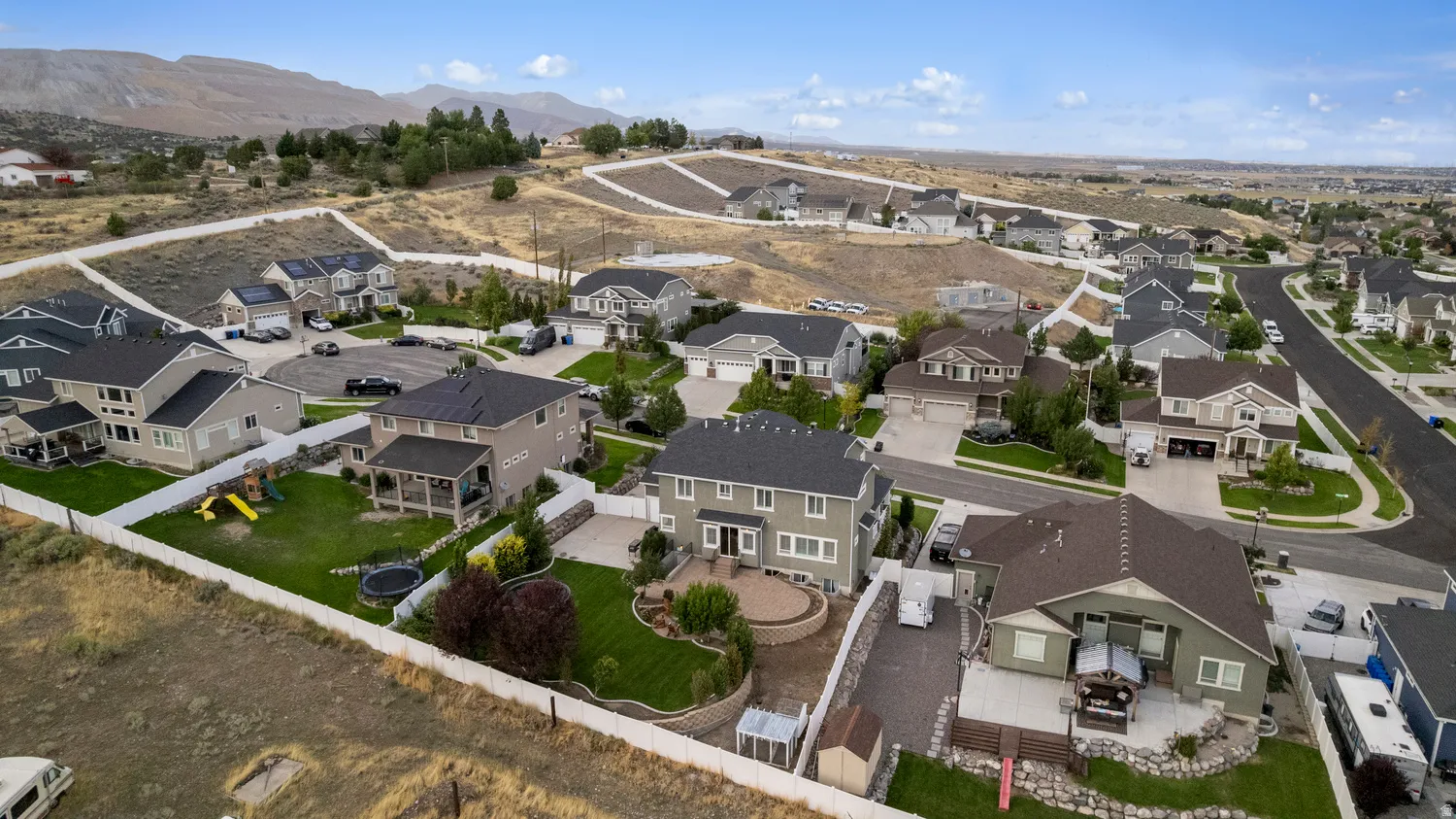 Residential neighborhood featuring varied architectural styles and mountain scenery