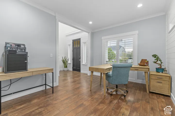 Wood-finish flooring throughout, recessed lighting, and a window with plantation shutters