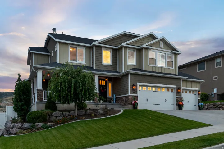 Two-story exterior with multi-toned siding, stone accents, and a covered porch