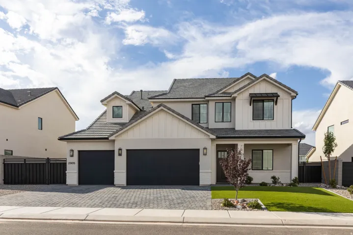 Contemporary two-story residence with a gray tile roof and white board-and-batten siding accents