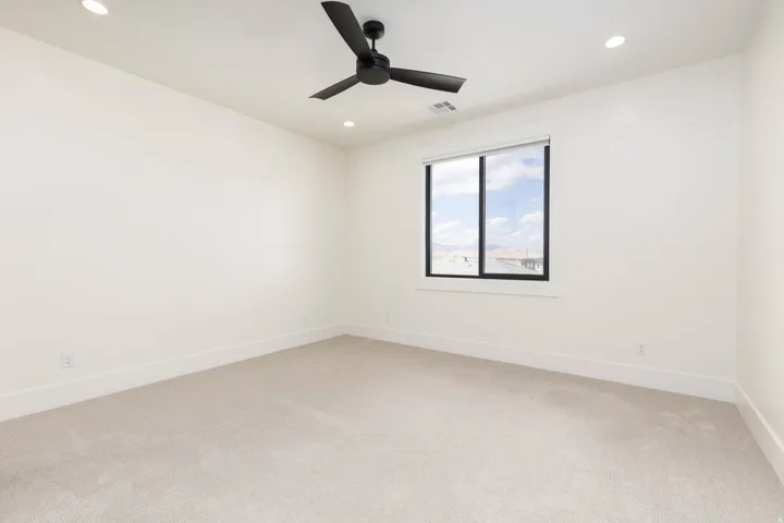 Recessed lighting, ceiling fan, white walls, and carpet flooring