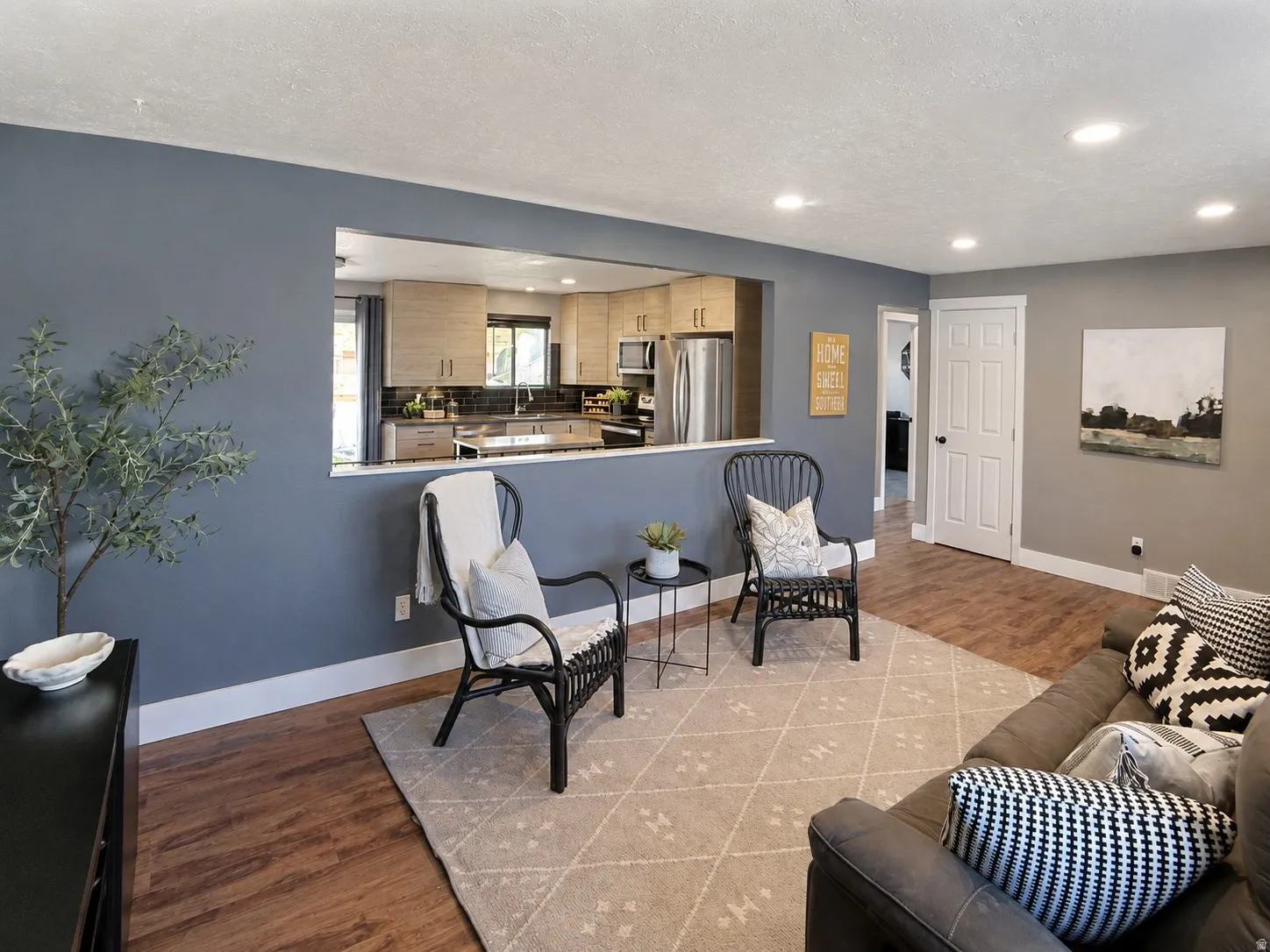 Large living room with cutout to kitchen, making it feel even more spacious.