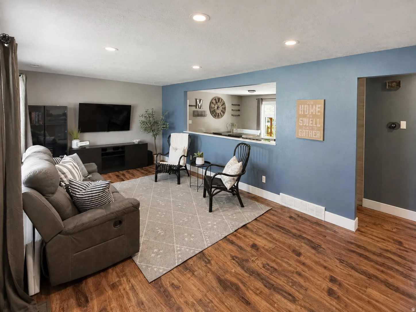Large living room with cutout to kitchen, making it feel even more spacious.