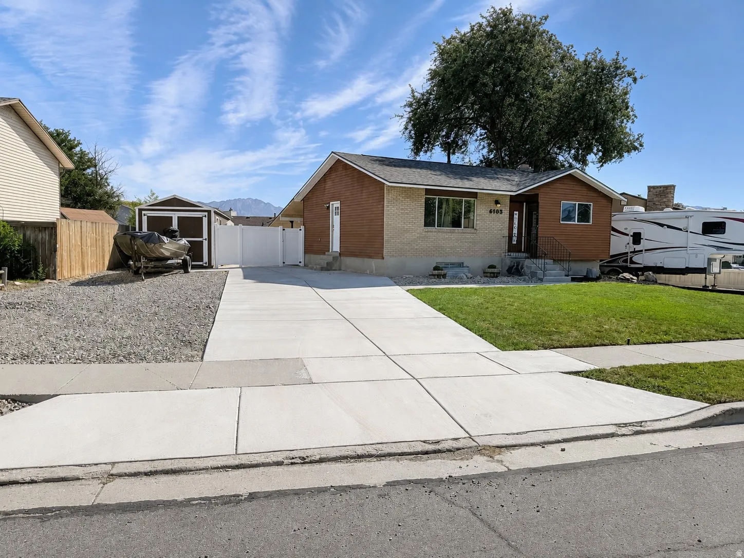 Charming rambler with spacious shed, new concrete driveway, and enough parking for 2 RVs!