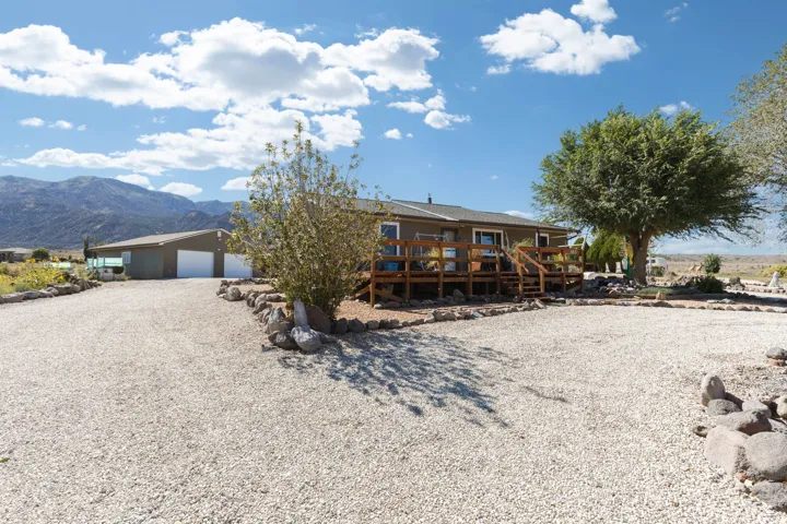 Gravel driveway with rock border landscaping