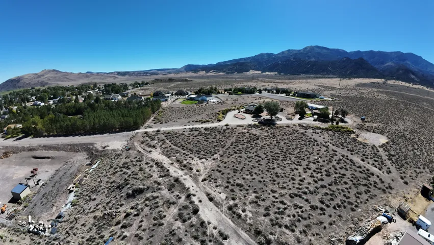 Expansive land parcel with mountainous terrain, featuring a clear, arid landscape