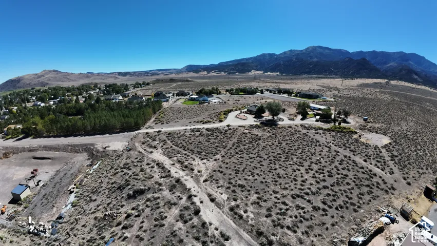 Expansive land parcel with mountainous terrain, featuring a clear, arid landscape