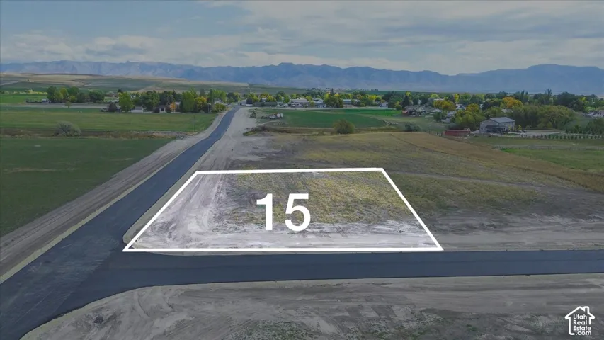 Corner lot featuring paved road access and mountain range scenery