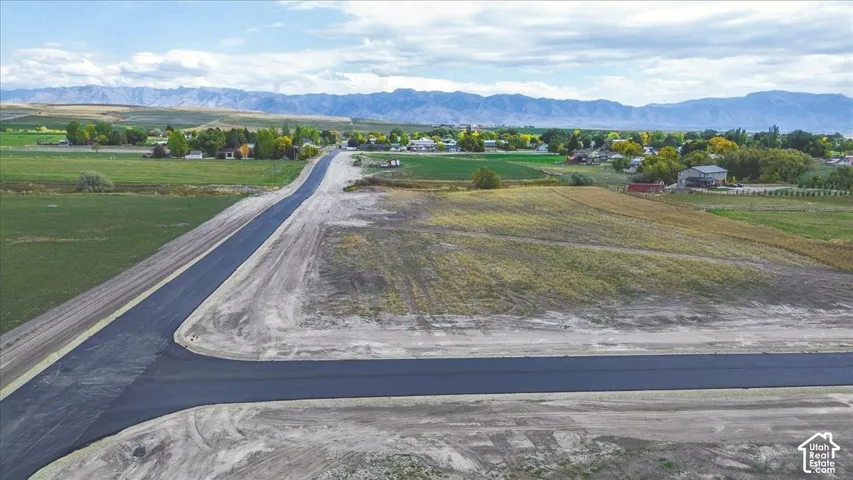 Vacant land parcel featuring paved road access, leveled topography, and expansive mountain scenery