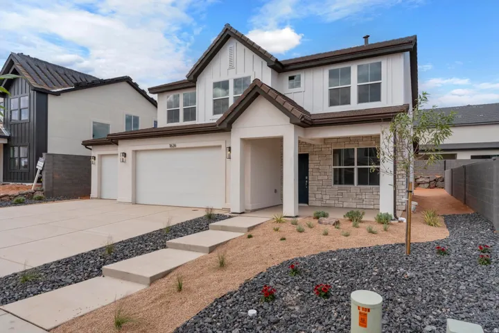 Modern two-story exterior with white siding and stone accents