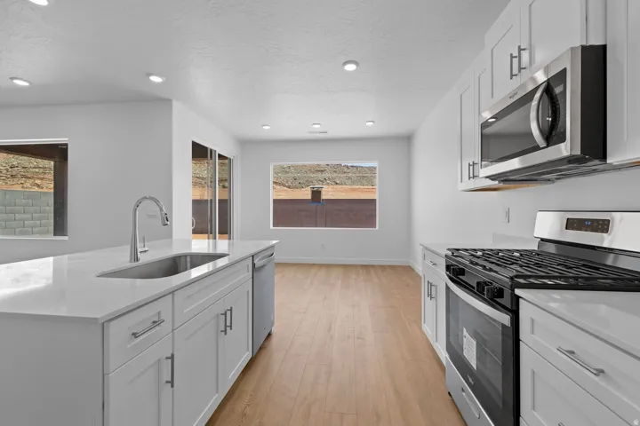 White shaker cabinetry paired with stainless steel appliances