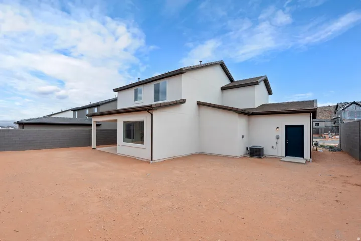 Contemporary exterior with a covered patio, multiple windows, and a dark tile roof