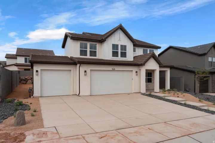 Two-story stucco exterior with board and batten accents, a two-car garage, and a covered entry