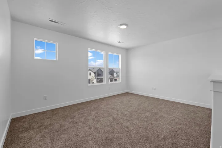 Neutral painted walls and brown carpet flooring