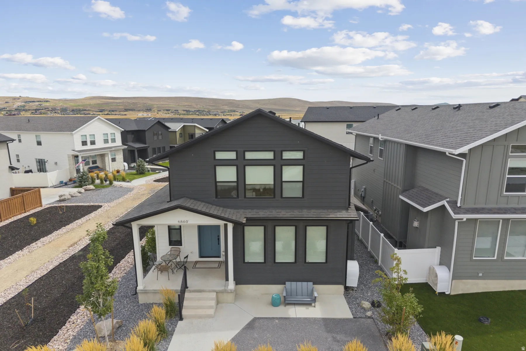 Modern two-story exterior with dark siding and contrasting trim