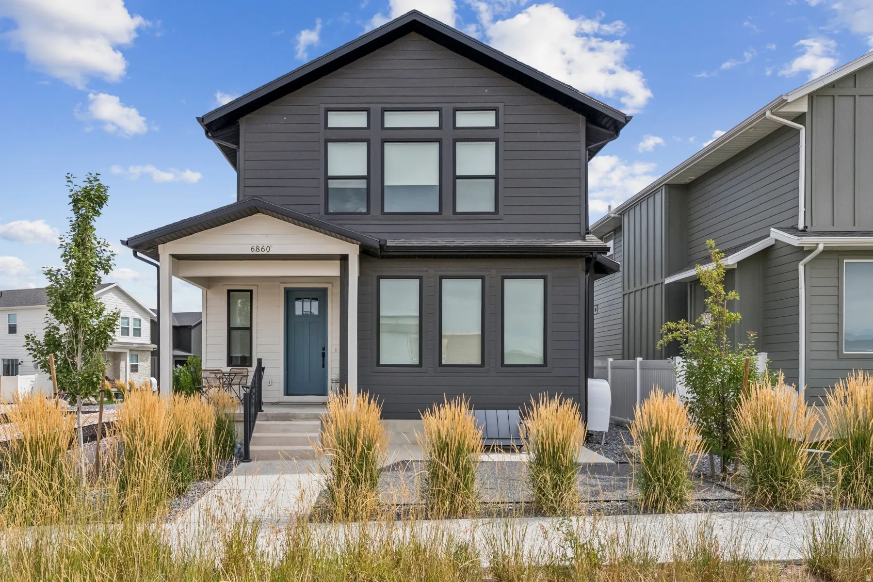 Modern facade with dark gray siding and white trim accents