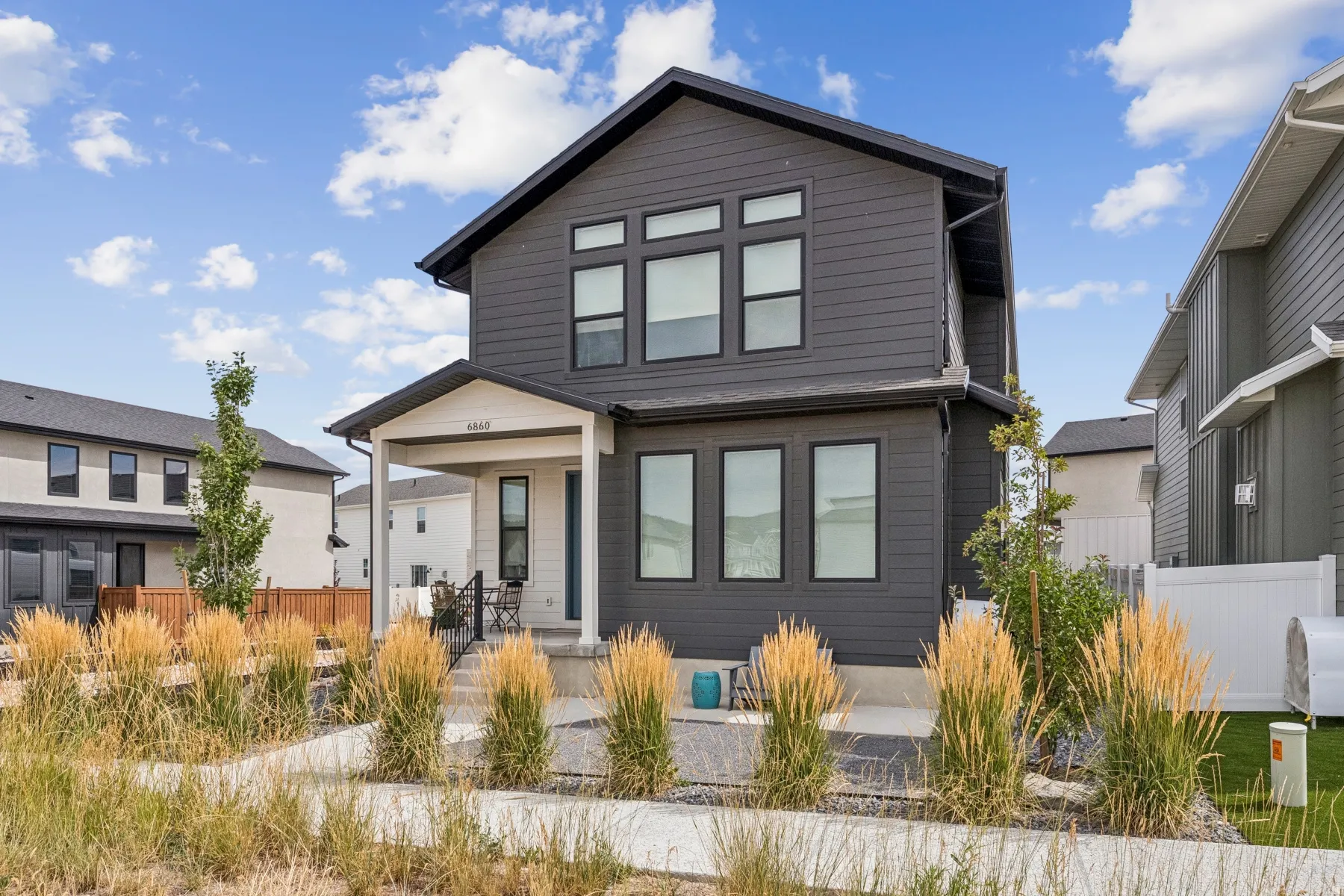 Contemporary two-story exterior with dark siding and white trim