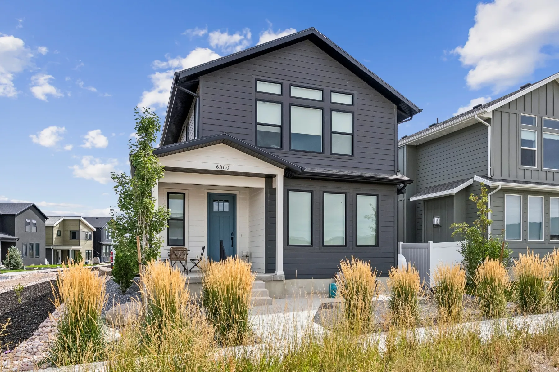 Contemporary exterior with dark gray siding and white trim