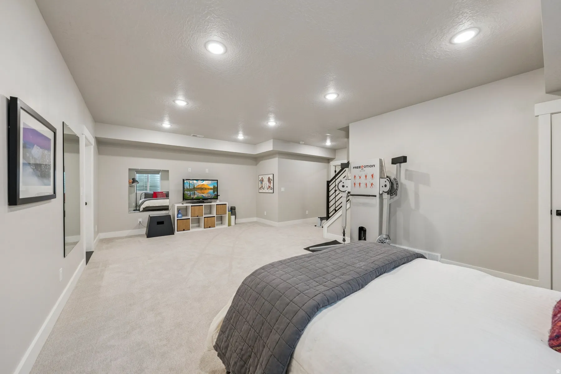 Spacious room with recessed lighting, light-toned carpeting, and neutral wall tones