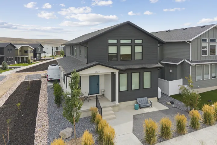 Modern two-story residence featuring dark siding and white trim