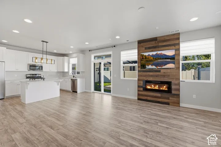 Living, dining, and kitchen with LVP.