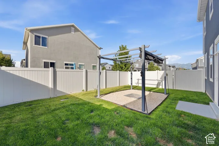 Fenced backyard with pergola