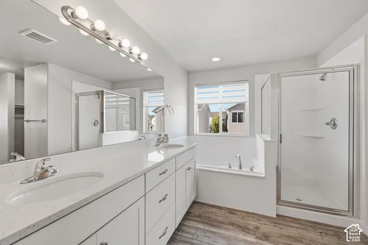 Primary bathroom with double sinks, separate tub and shower