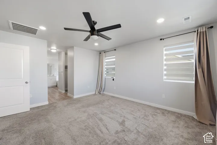 Primary bedroom leading to large bathroom
