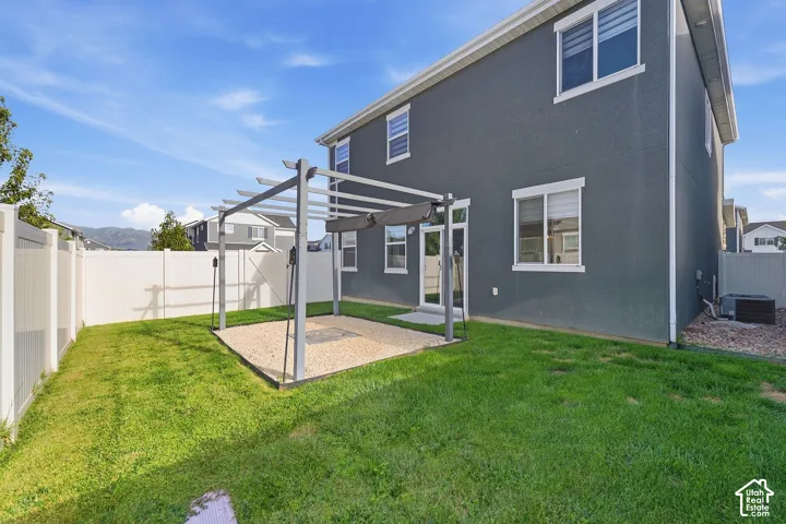 Fenced backyard with pergola