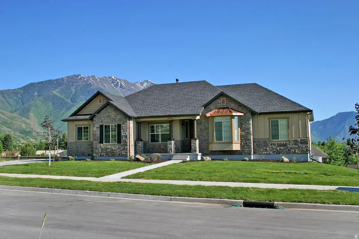 Stone and siding exterior with a shingle roof