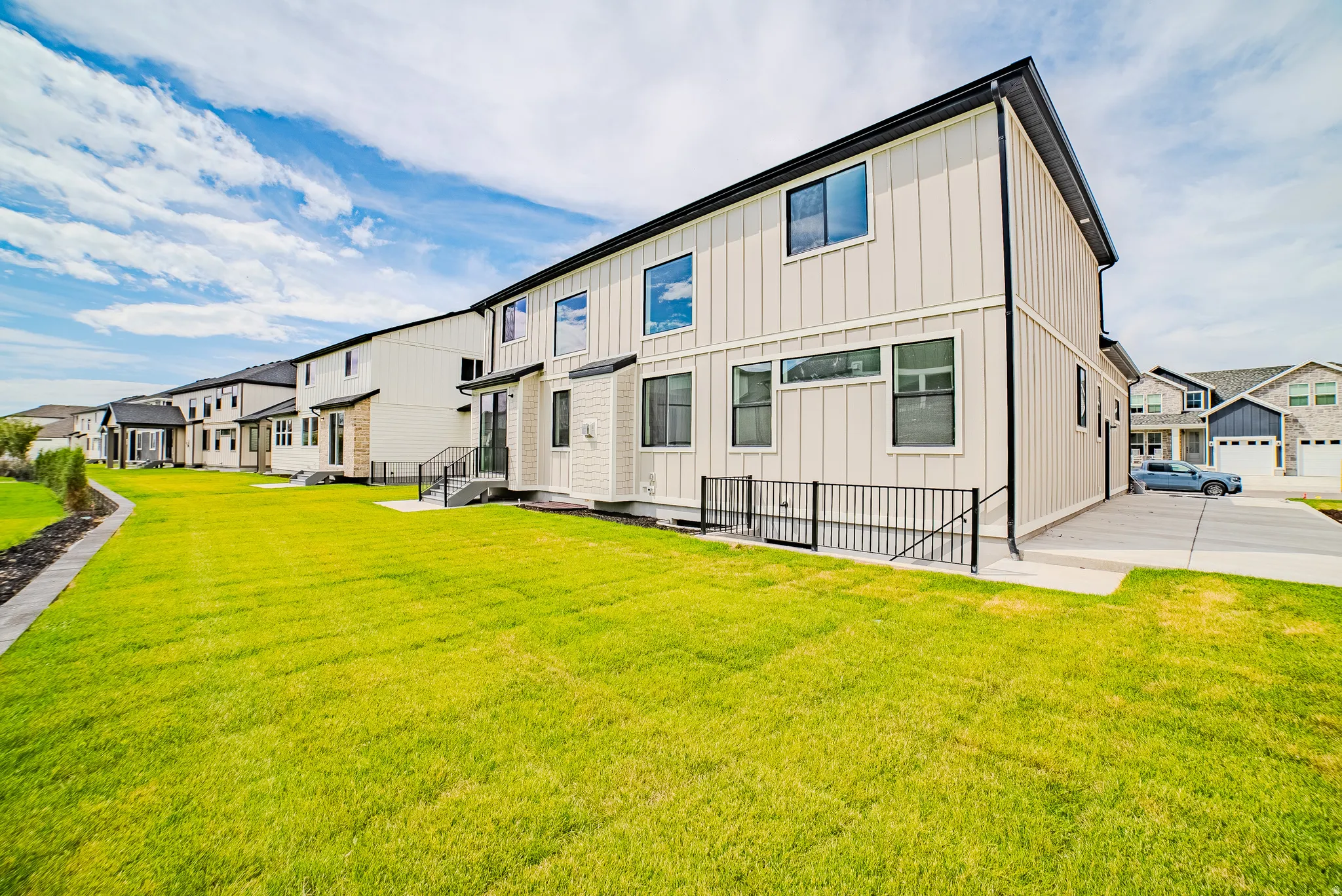 Expansive green lawn bordering a concrete walkway
