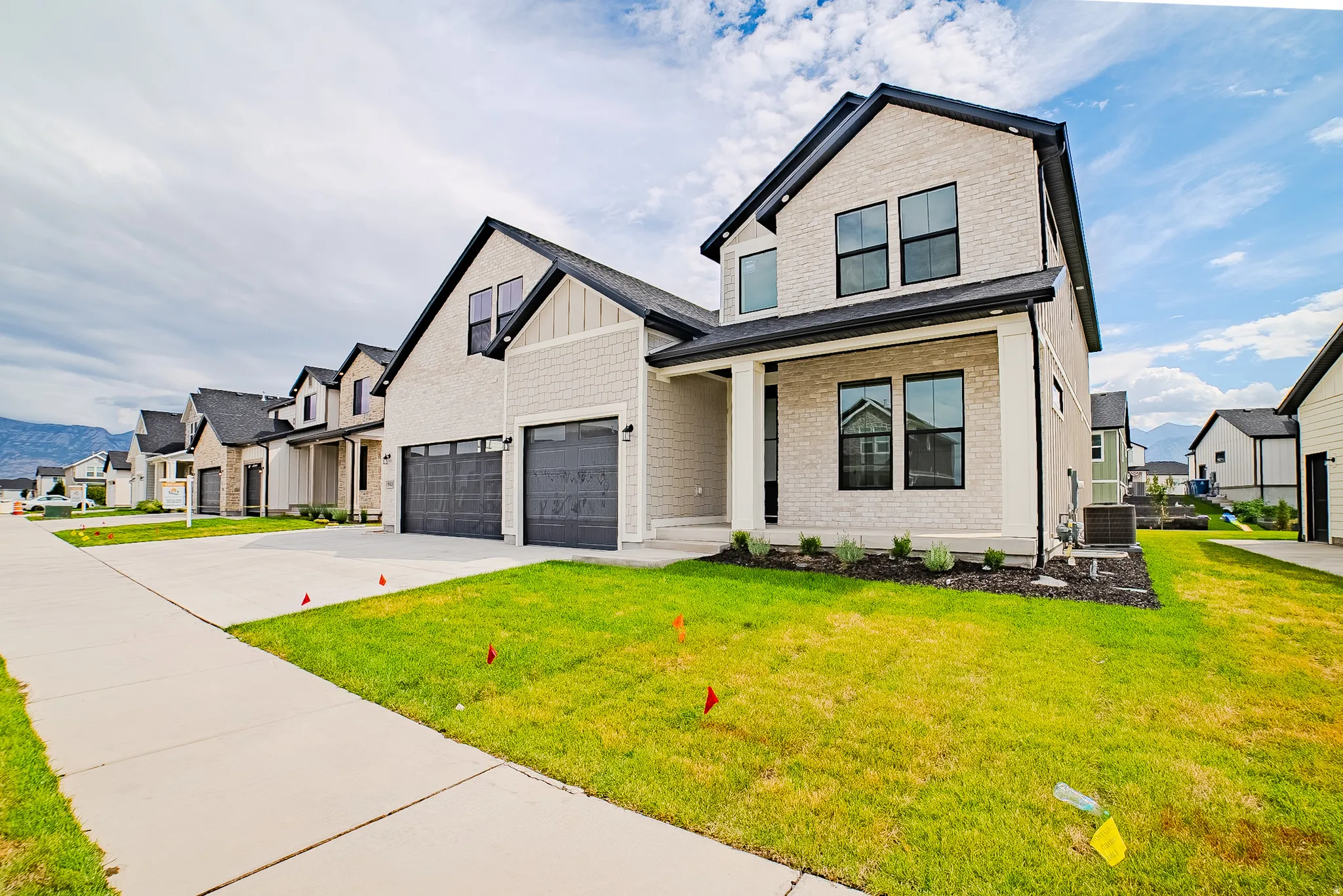 Two-story exterior with light-colored brick and horizontal siding accents