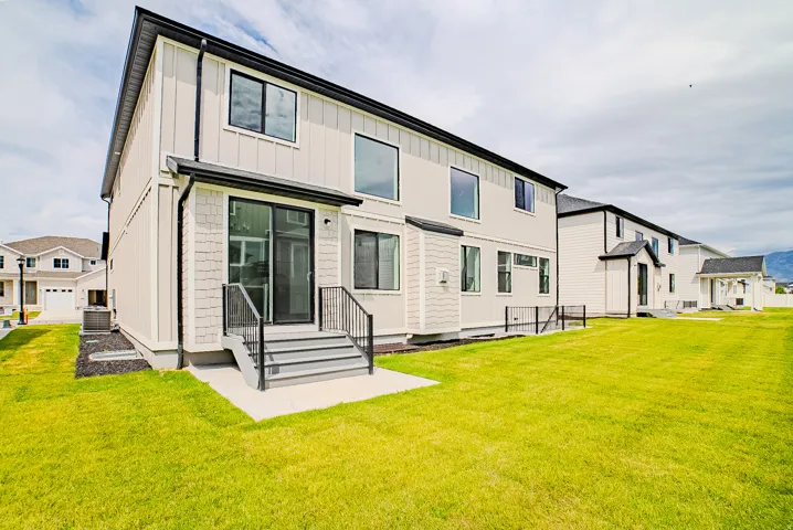 Exterior featuring vertical siding and shingle accents, black-framed windows, and a sliding glass door