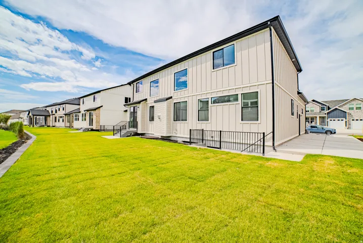 Expansive green lawn bordering a concrete walkway