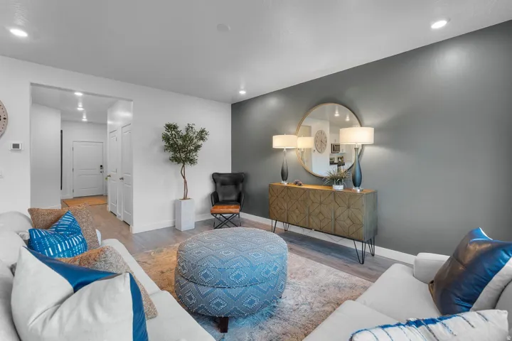 Recessed lighting, wood-finish flooring, two-tone wall treatment, built-in cabinetry with geometric detailing