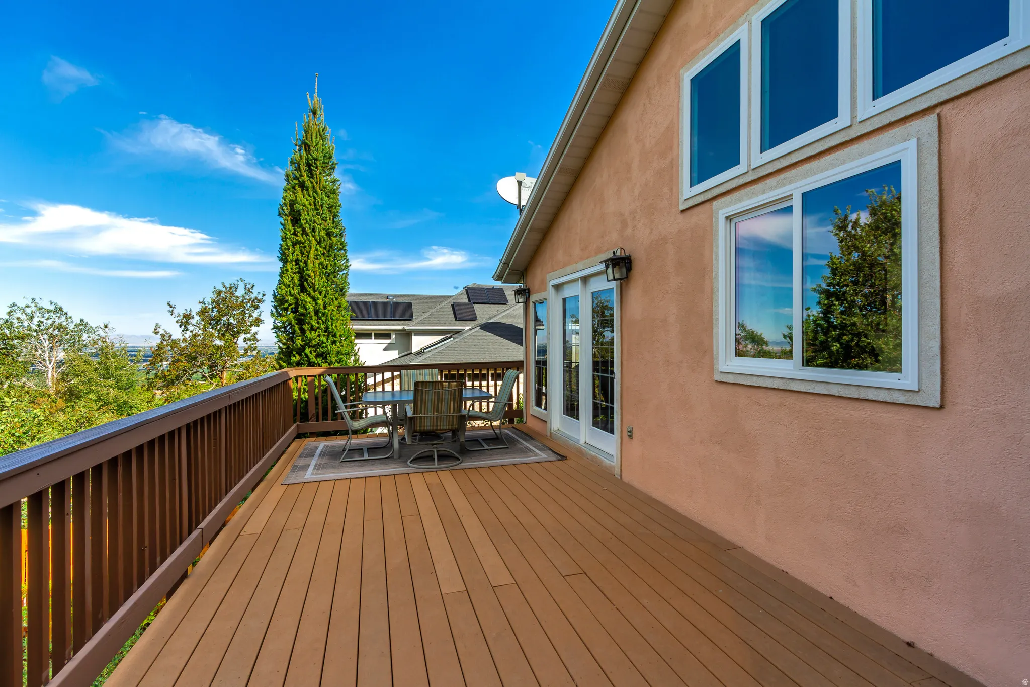 Expansive exterior deck featuring a wood-finish surface and matching railing