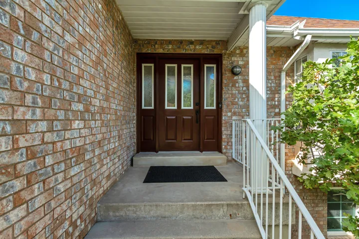 Brick exterior detailing a covered entry