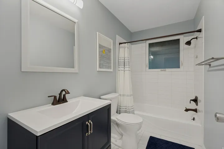 Integrated vanity with a white countertop and bronze-finish faucet