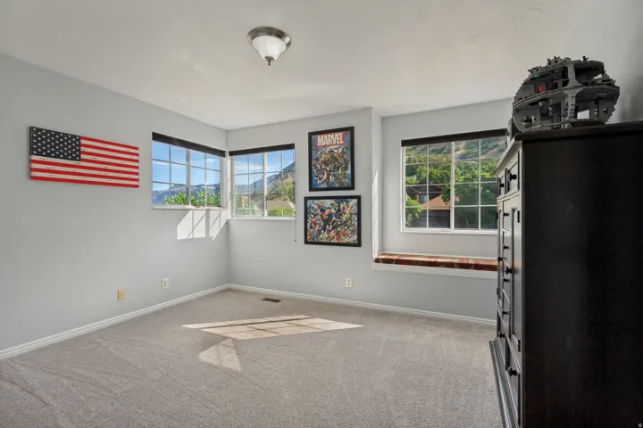 Carpeted flooring, multiple windows with grid patterns, window seating, and a flush mount light fixture
