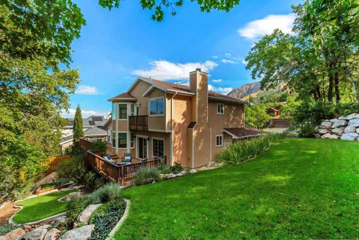Multi-level stucco exterior with a large wooden deck