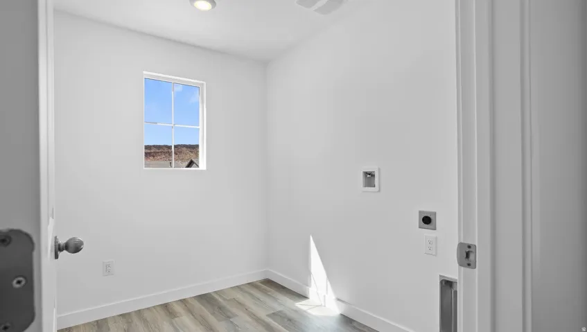 Recessed lighting, wood-finish flooring, and a single window