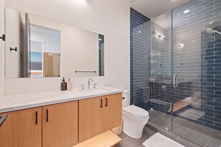 Wood-finish vanity with a white countertop and rectangular undermount sink