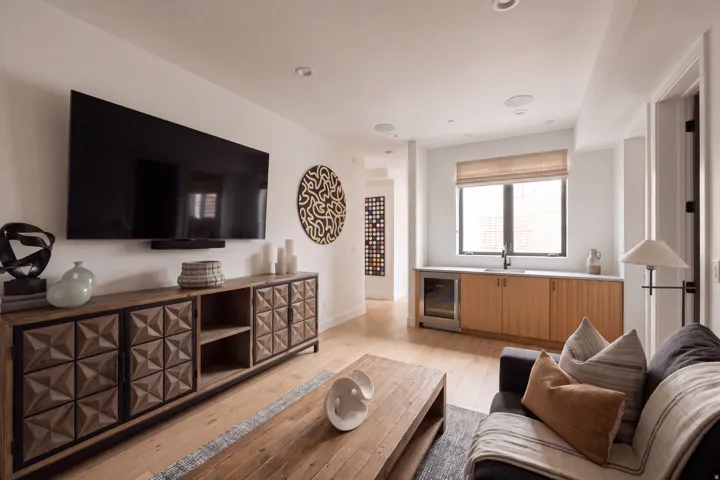 Recessed lighting, wood-finish flooring, and built-in wet bar with a beverage refrigerator